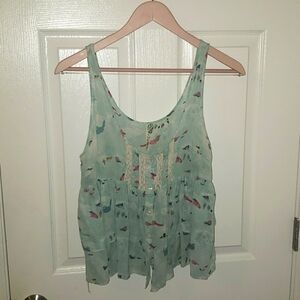 Free People whimsical top.  Size M  Beautiful top amd material.  A MUST HAVE.